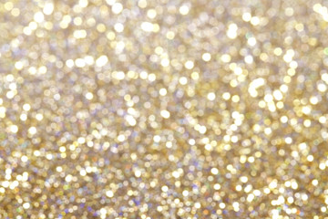 Glitter and glow soft gold bokeh shining light abstract dreamy sparkle background