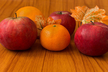 Apples and Oranges on brown background