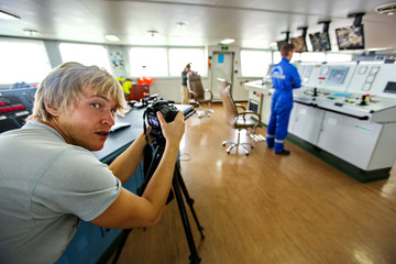 Photographer reporter photographing the operator control panel. Everyday life of the photographer