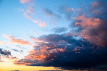 Beautiful bright sunset sky with fluffy clouds