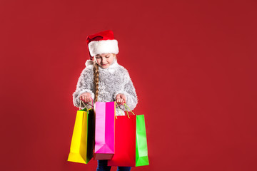little girl with a laptop buys gifts for the new year. 