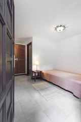 Small apartment room / bedroom with wooden furniture