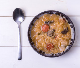 Christmas cabbage soup with mushrooms on white background.