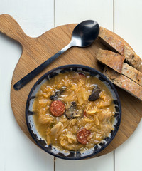 Christmas cabbage soup with mushrooms on white background.