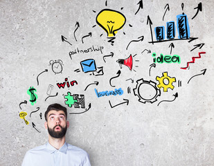 Thoughtful guy with business sketch