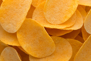 Close up potato chips on wood top view background.