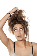 Fototapeta premium unhappy girl holding her hair on white background