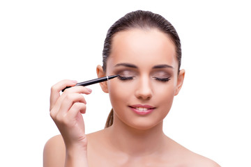 Fototapeta premium Woman getting make-up isolated on white