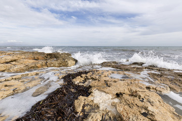 Obraz premium Rocky beach with waves in Santa Pola, Alicante province, Spain.