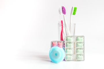toothbrushes in glass on white background tools for oral care