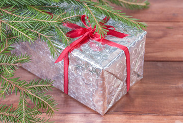 Fototapeta na wymiar Shiny box with a gift under the tree