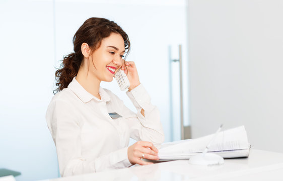 Friendly Woman Behind Reception Desk Administrator