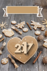 Christmas heart shaped gingerbread background. 2017 Winter holidays atmosphere. Snoflakes. Hand drawn ribbon for copy.Perfect for greeting cards, flyers, etc.Space for copy