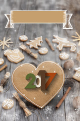 Christmas heart shaped gingerbread background. 2017 Winter holidays atmosphere. Snoflakes. Hand drawn ribbon for copy.Perfect for greeting cards, flyers, etc.Space for copy