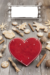 Christmas heart shaped gingerbread background. Winter holidays atmosphere. Snoflakes. Hand drawn ribbon for copy.Perfect for greeting cards, flyers, etc.Space for copy