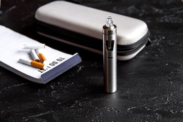 elimination of tobacco smoking electronic cigarette on dark background