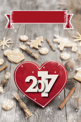 Christmas heart shaped gingerbread background. 2017 Winter holidays atmosphere. Snoflakes. Hand drawn ribbon for copy.Perfect for greeting cards, flyers, etc.Space for copy