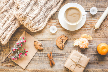 Christmas muffler with cup of cocoa wooden background top view