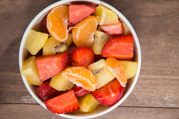 ftuits salad on the wood background.