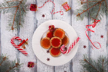 Christmas Baking Cookies with Marmalade on White Wooden Background with crackling effect.Traditional Sweets cane.Holiday card.selective focus