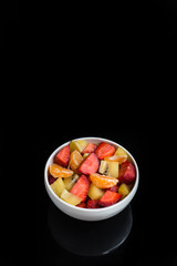 ftuits salad on the black background.