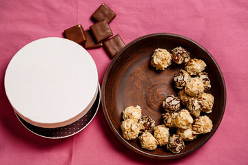 Chocolate candies over pink background. Above.