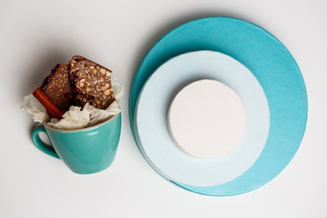 Chocolate in cup and boxes over white background. Above.