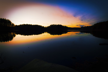 Fototapeta premium Sunset on a forest lake.