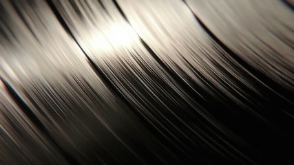 Sharp focus on a macro vinyl disc with it's grooves playing and spinning