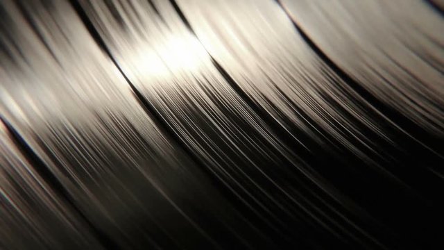 Sharp focus on a macro vinyl disc with it's grooves playing and spinning