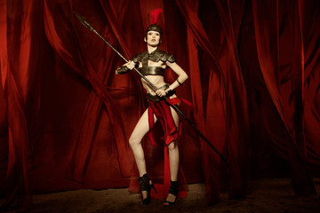 Fototapeta na wymiar Woman in armour and helmet holding spear