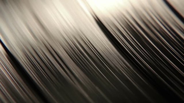 Sharp focus on a macro vinyl disc with it's grooves playing and spinning