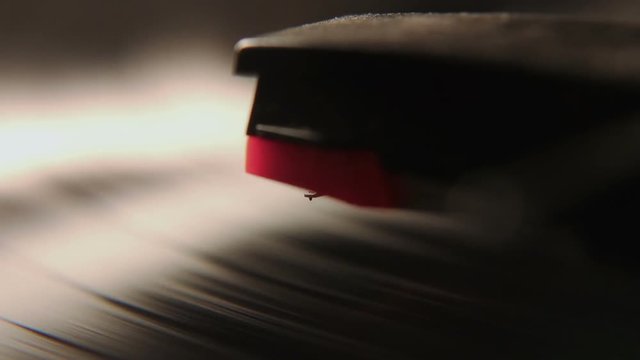 Closeup Shot Of A record Player Arm Touching The Vinyl Record To Start It Playing