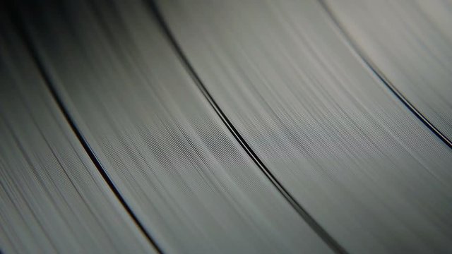 Macro Closeup Of A Vinyl Record Disc Showing It's Grooves As The Disc Spins Around
