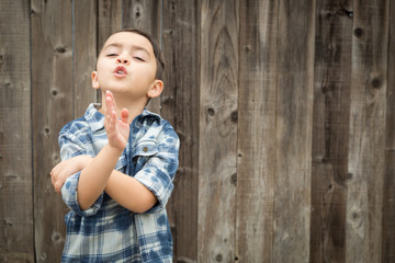 Happy Young Mixed Race Boy Portrait Against Wooden Fence.