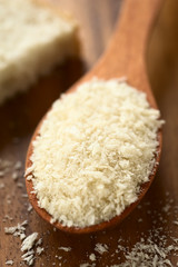Panko Japanese flaky bread crumbs on wooden spoon, photographed with natural light (Selective Focus, Focus one third into the breadcrumbs on the spoon)