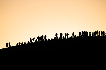 People enjoy sunset on the dunes