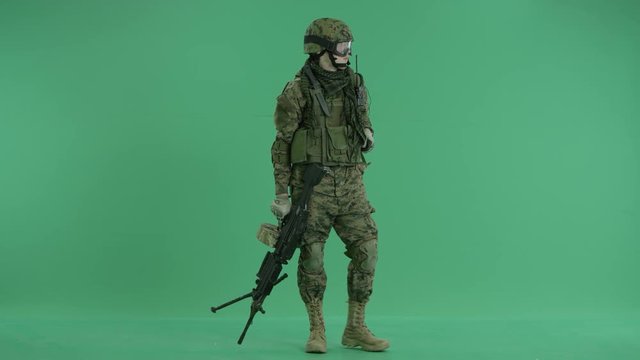 Soldier using gas mask and looking around at green screen