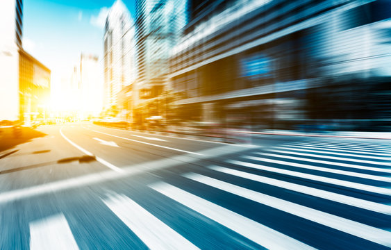 Road Intersection In Midtown Of Modern City At Sunrise