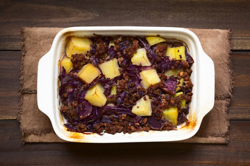 Baked red cabbage, apple, mincemeat and potato casserole in dish, photographed overhead with natural light (Selective Focus, Focus on the top of the dish)