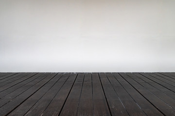 Wooden floor with white wall