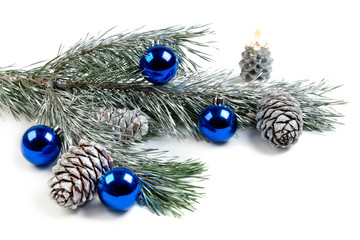 Pine branches with silver cones and blue balls on white background