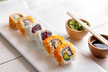 california roll and tuna avocado roll on white plate