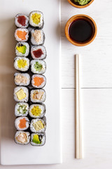 japanese food mini maki sushi platter on white wooden table