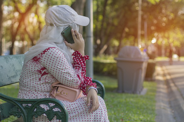 Woman sitting on the phone in the park