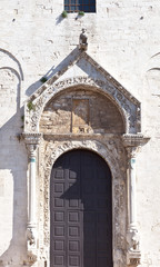 Fototapeta na wymiar Basilica of St. Nicholas. Gate icon and stone carving around the door (beginning of XII century). Bari. Italy