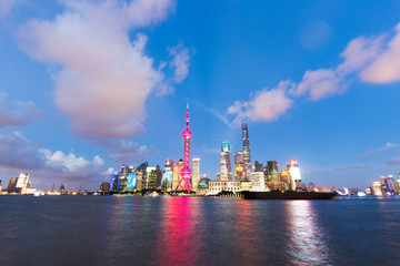 Naklejka premium modern office buildings near illuminated orient pearl tower by r