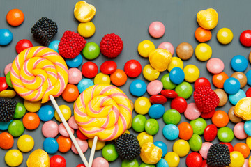 Fototapeta na wymiar Colorful candies on wooden background