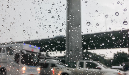 Blurred rain drop on the car glass background, water drops at the car window