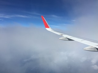 View of clouds from the airplane.Aerial view of cloud and blue sky with wing's airplane.Traveling and journey concept.